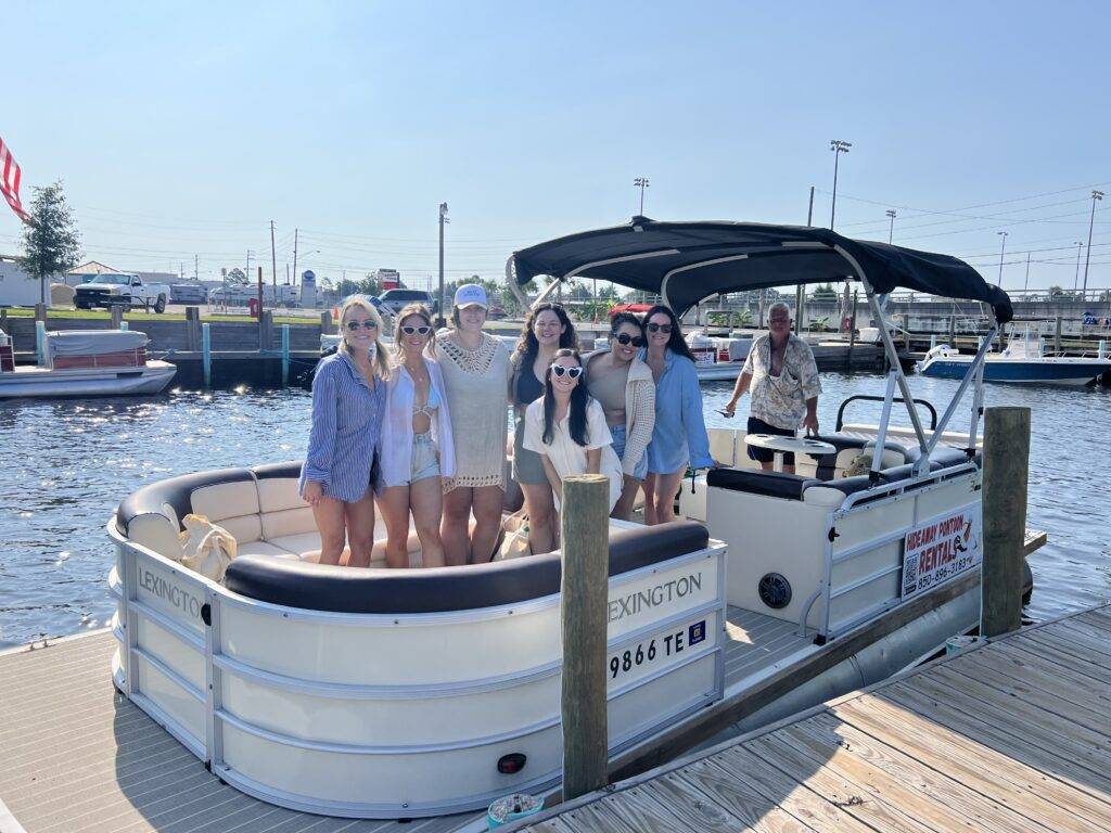 A joyful group aboard a "Lexington" 12-person pontoon rental, ready for a sunny day out.