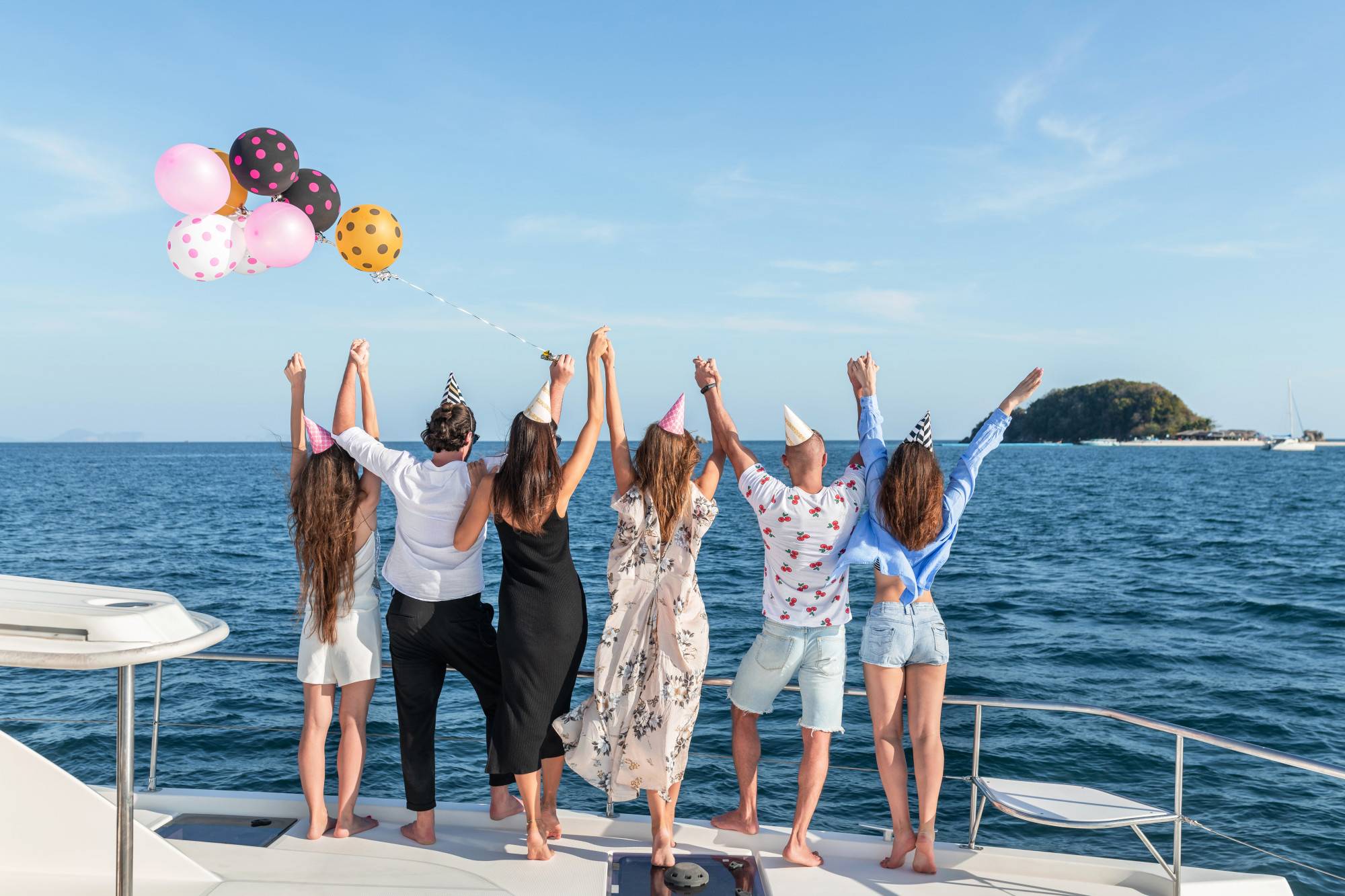 Group of friends enjoying a pontoon party Panama City, with balloons.