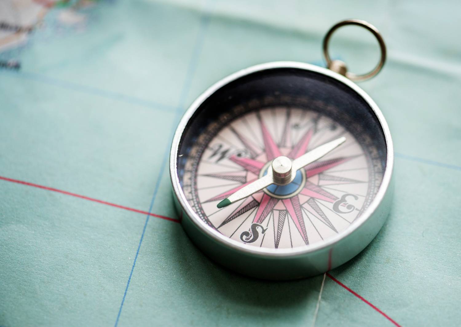 Vintage compass on a map, essential for navigating 11-person pontoon boats.