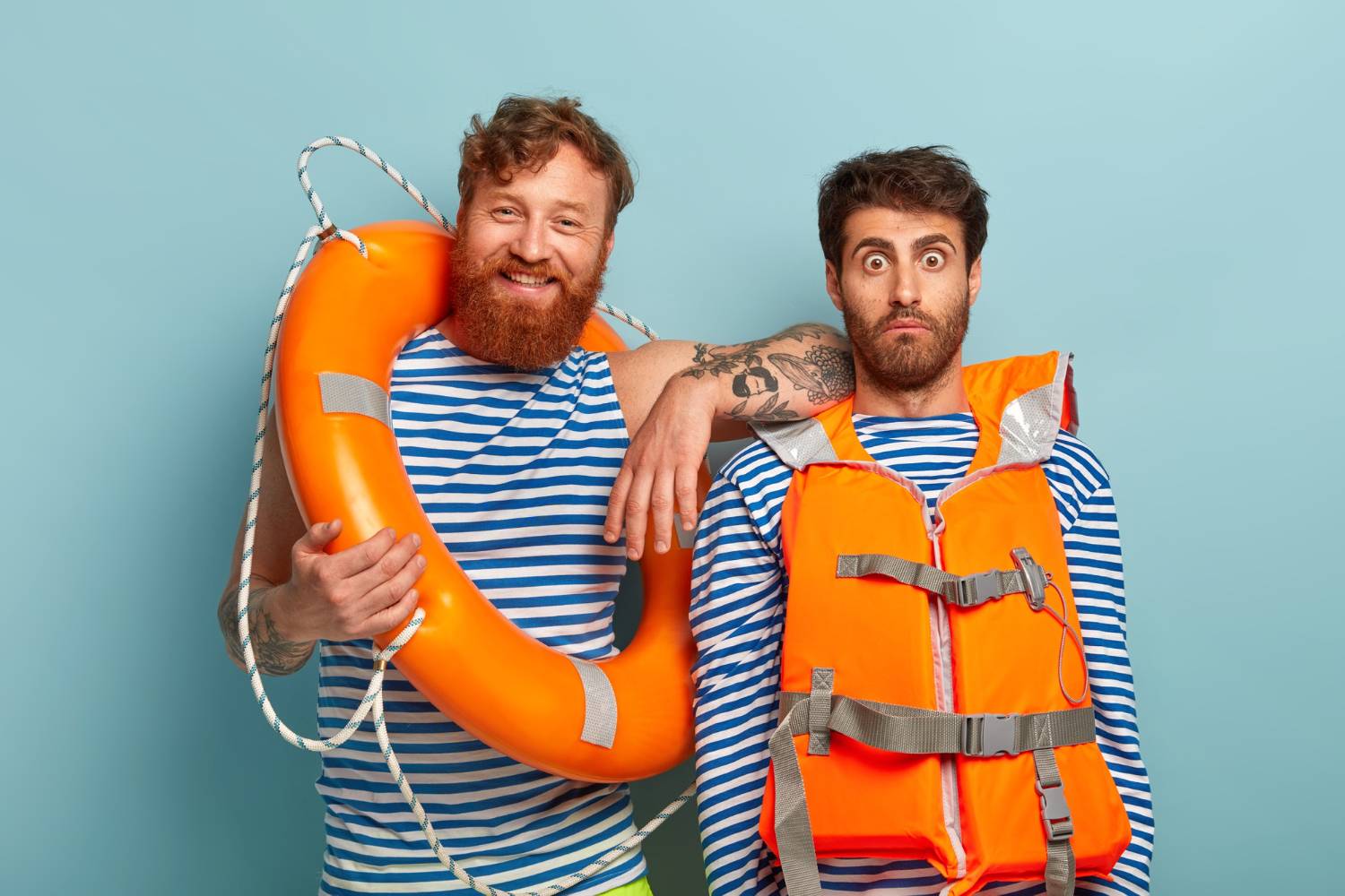 Two cheerful men in nautical outfits, ready for a safe voyage on an 11-person pontoon boat.