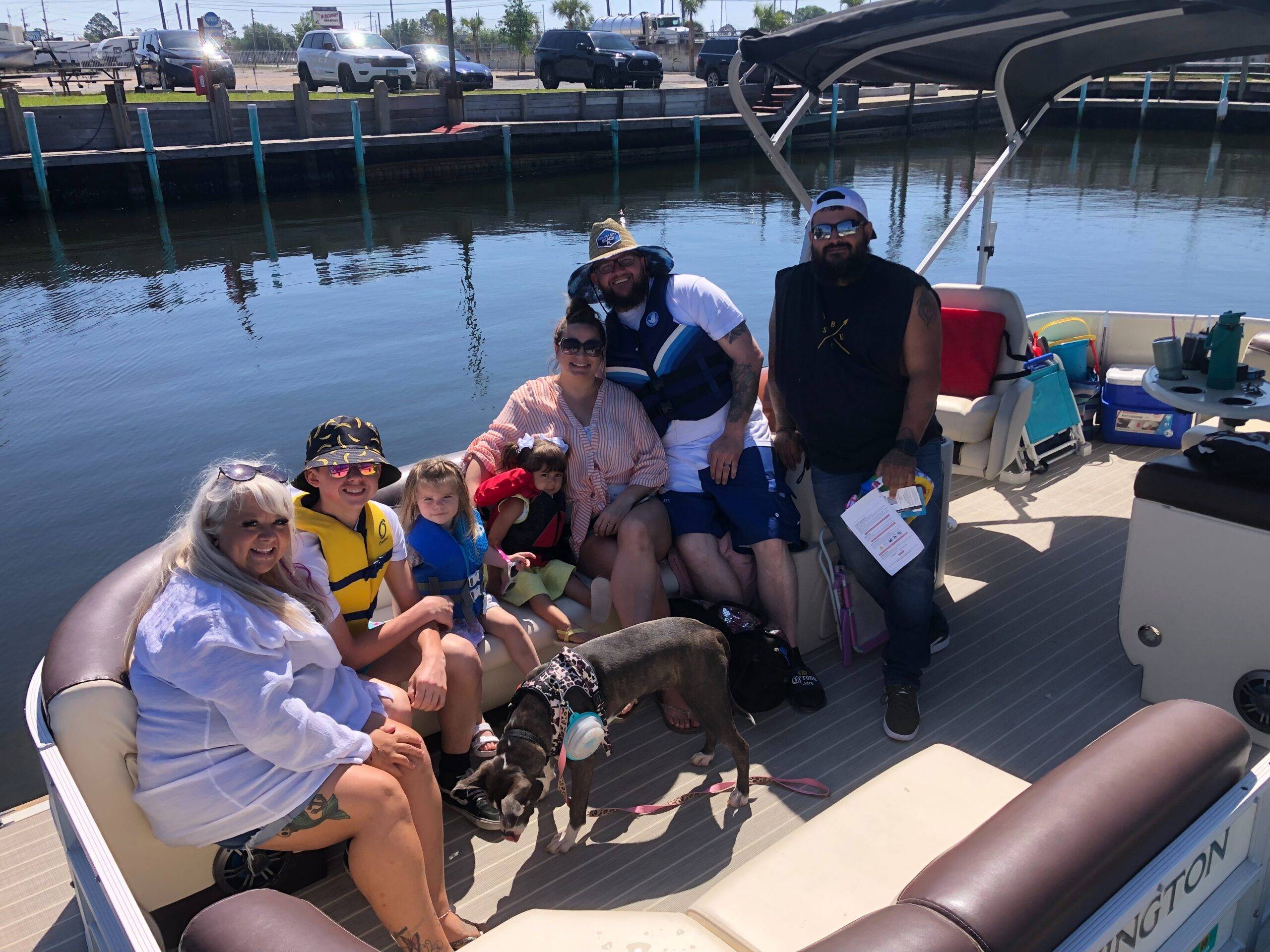 Happy family with a dog on a Panama City pontoon rental, ready for a fun day out.