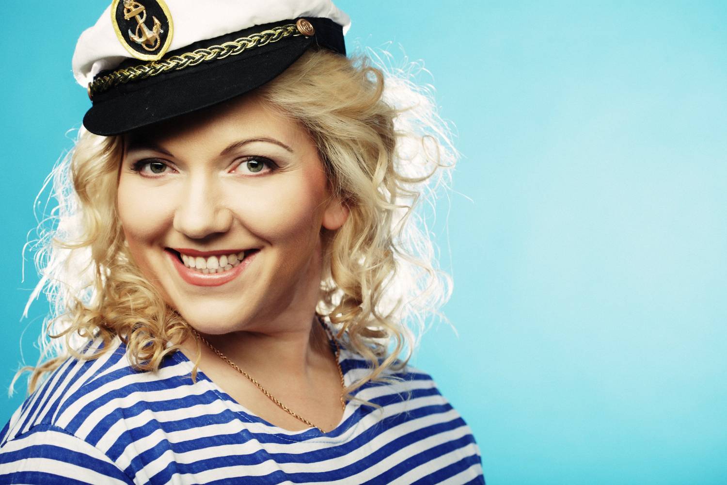 Smiling woman in sailor hat, ideal for 10 person pontoon boats.
